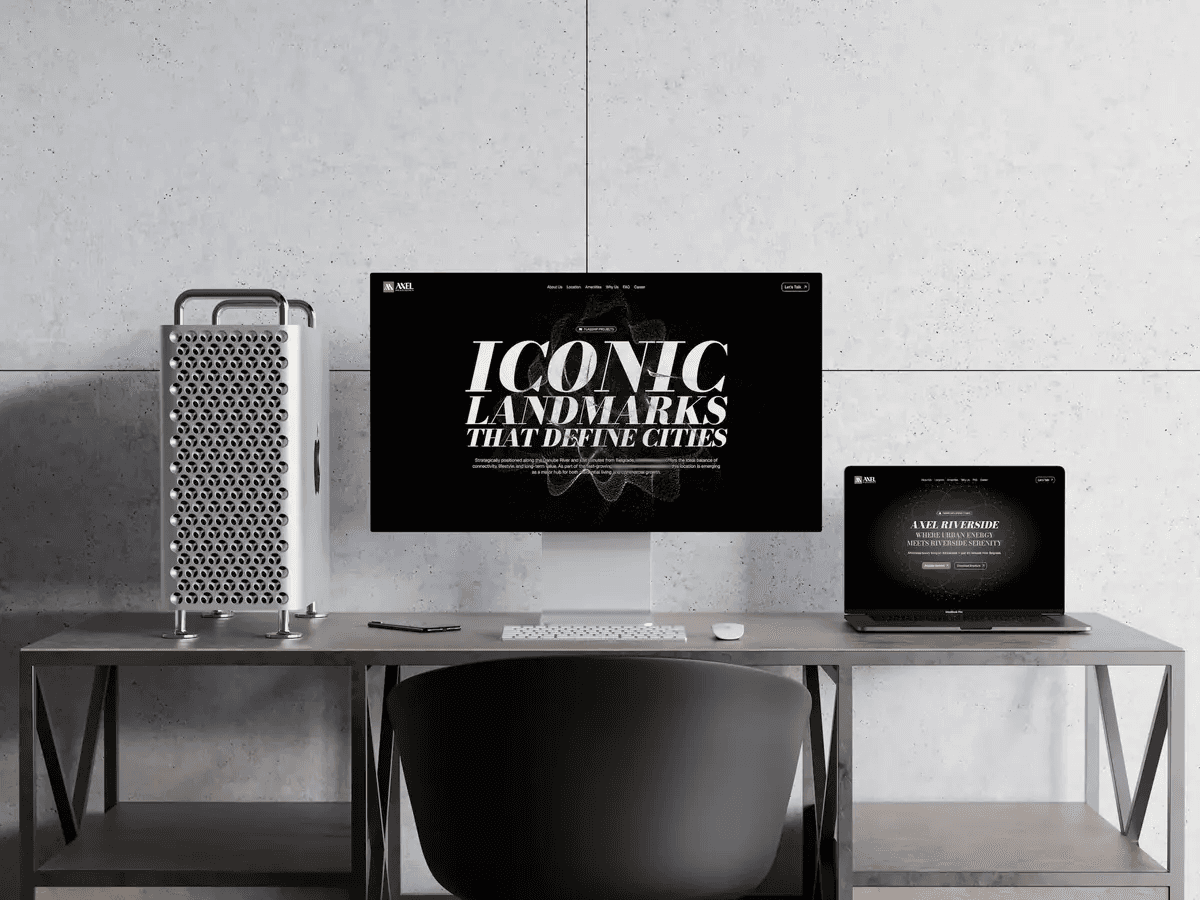 The website on a desktop monitor and a laptop: a tall serif headline over a dark hero.